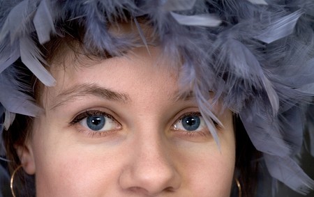 Portrait of the girl with a boa on a head closeupの写真素材