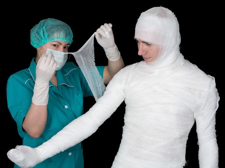 Doctor give bandaged patient on the blackの写真素材