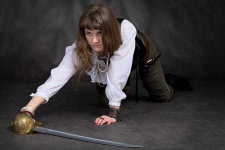 Girl on all fours on black with rapierの写真素材