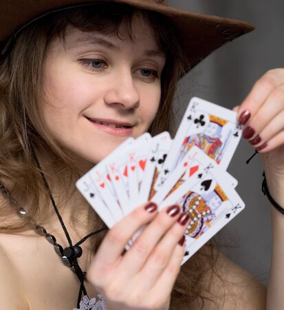 Portrait girl with a playing-cards in hand on blackのeditorial素材