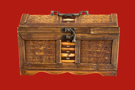 Ancient wooden chest on the red background