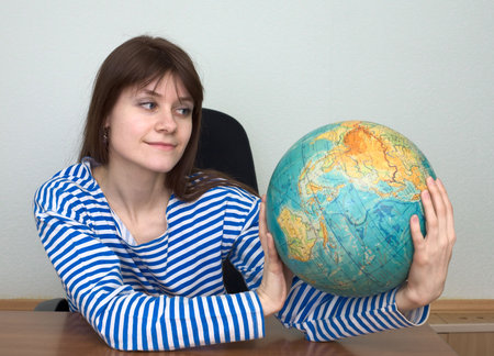 Woman in a stripped vest with terrestrial globe