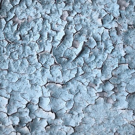 Surface of an old blue wall with cracksの写真素材