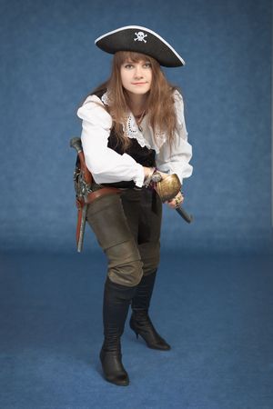 Beautiful girl - the pirate on a blue background with saberの写真素材