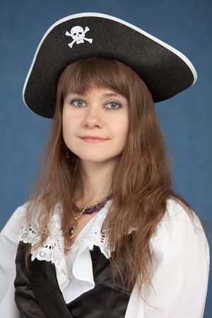 Portrait of pirate girl in black hat on a blue backgroundの写真素材