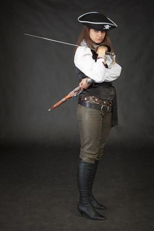 Girl - pirate with sabre and pistol on a black backgroundの写真素材