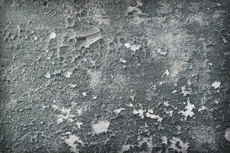 Concrete wall covered with an old shabby paintの写真素材