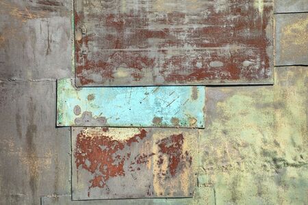 Surface of a wall covered with sheets of rusty old ironの写真素材