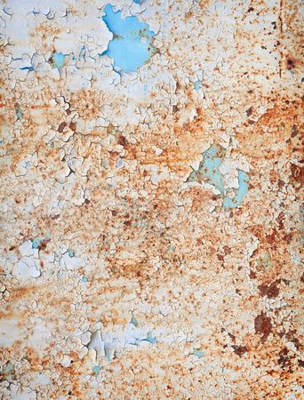 The rusty weathered surface of a steel sheet with paint scrapsの写真素材