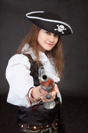The young woman in a suit of the pirate aims a pistolの写真素材
