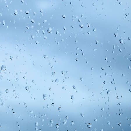Texture from droplets of rain water on a windowpane surfaceの写真素材