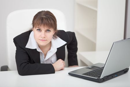 Resolutely woman - the managing director sits at a table with the laptopの写真素材