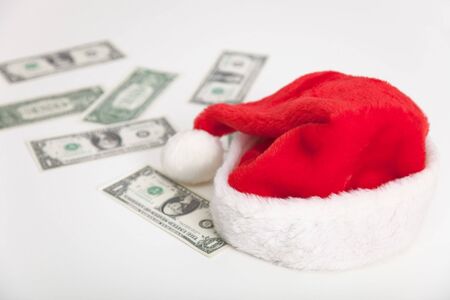 Christmas santa hat and dollars on gray surfaceの写真素材