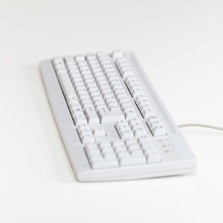 The computer keyboard lies on a table surface