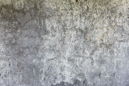 The dark gray grunge concrete weathered wall backgroundの写真素材