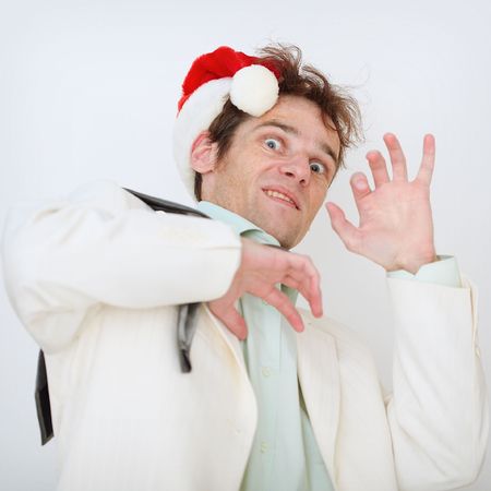 Portrait of the scared person in a New Year hat on a white backgroundの写真素材