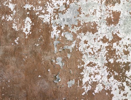 Concrete wall covered cracked paint and a dirt backgroundの写真素材