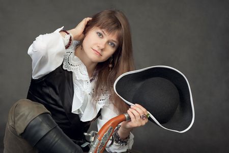 The young beautiful woman in a costume of the pirate on a black backgroundの写真素材