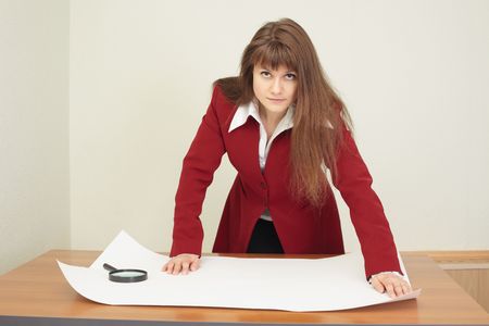 The young woman - the engineer works with the big drawingの写真素材
