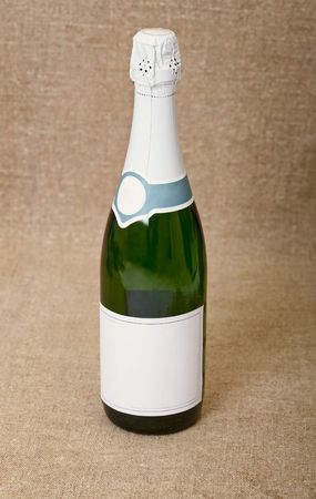 One bottle of sparkling wine against a draperyの写真素材