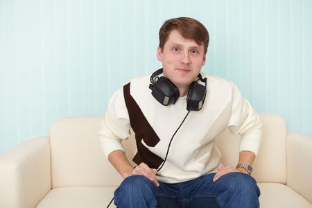 The man with the head-phones on a sofaの写真素材