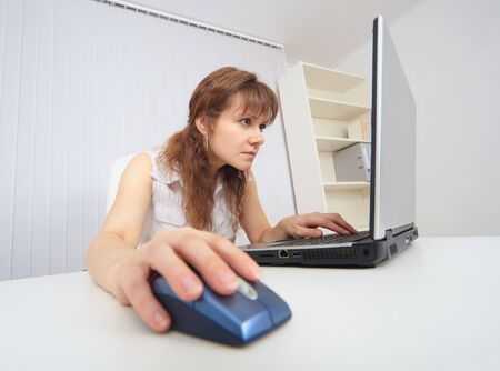 The young woman with concentration works in the Internetの写真素材