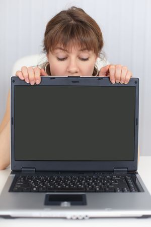 The woman and the blank screen of the laptopの写真素材
