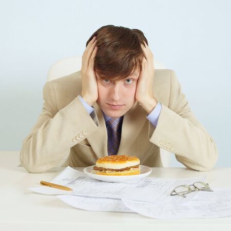 The person at office on a workplace with a hamburgerの写真素材