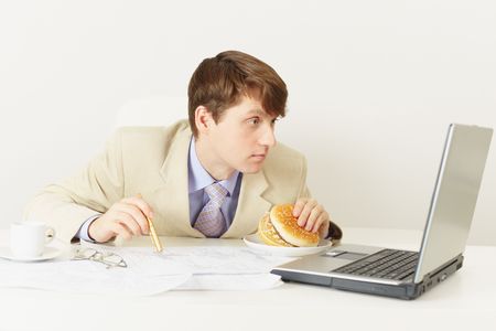 The person is going to have dinner a sandwich at officeの写真素材