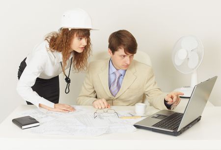 Two young engineers work over the project on the laptopの写真素材