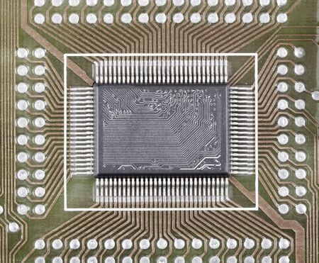 Old integrated microcircuit on a circuit board surfaceの写真素材