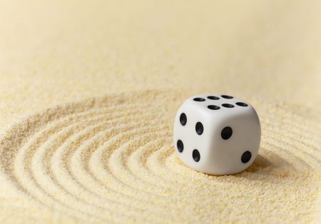 Playing white dice on a surface of yellow sand - an art miniatureの写真素材