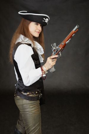 The young beautiful girl - the sea pirate with pistolの写真素材