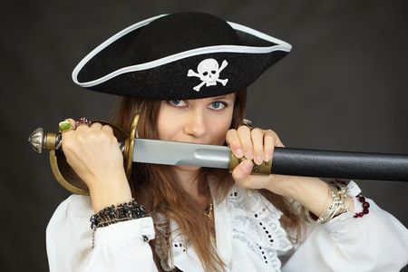 Woman pirate, demonstrates his sword, taking out from the sheathの写真素材