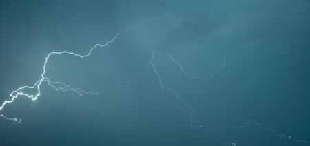 Panoramic photograph lightning flashes across the skyの写真素材