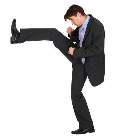Businessman kicks up, isolated on a white backgroundの写真素材