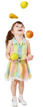 A little funny girl juggles fruit on white backgroundの写真素材