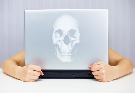Deadly laptop connected to the Internet on the tableの写真素材