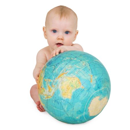 A baby sitting on a white background with a globeの写真素材