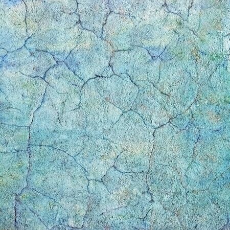 The pattern of cracks on the wall of the stone buildingの写真素材