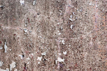 Dirty old stone wall with peeling paint rags