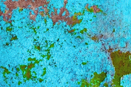 The old wall are covered with bright paint and cracks