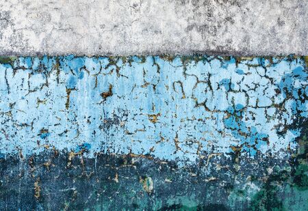Concrete old wall two different colors covered with rotting paintの写真素材