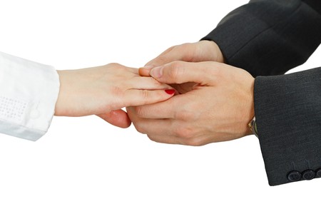 Women's hand in the men's hands, isolated on a white backgroundの写真素材