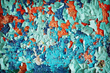 A wall covered with brightly colored flocks of the old, damaged paintの写真素材