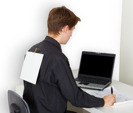 A man very busy with work. On the back is attached a piece of paper.の写真素材