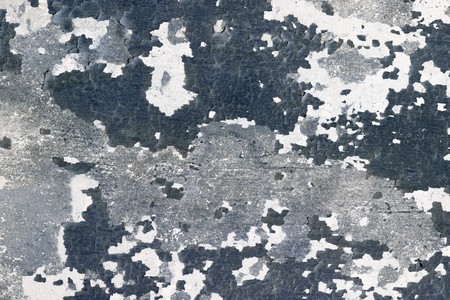 The surface of the wall with cracks and pieces of old paintの写真素材
