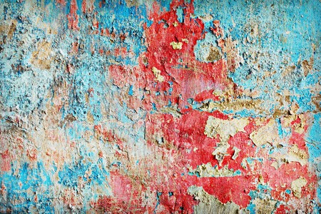 Weather-beaten paint different colors on the old wallの写真素材