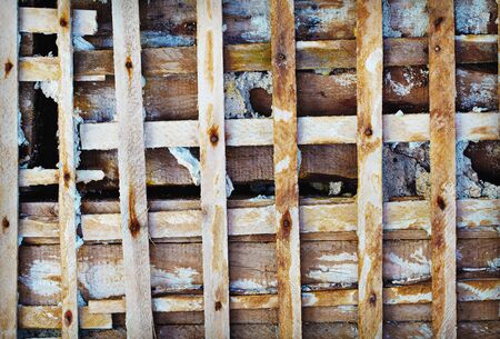 Dirty old wooden lattice - the skeleton of the concrete wallの写真素材