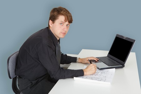 The young specialist working on a project in the officeの写真素材
